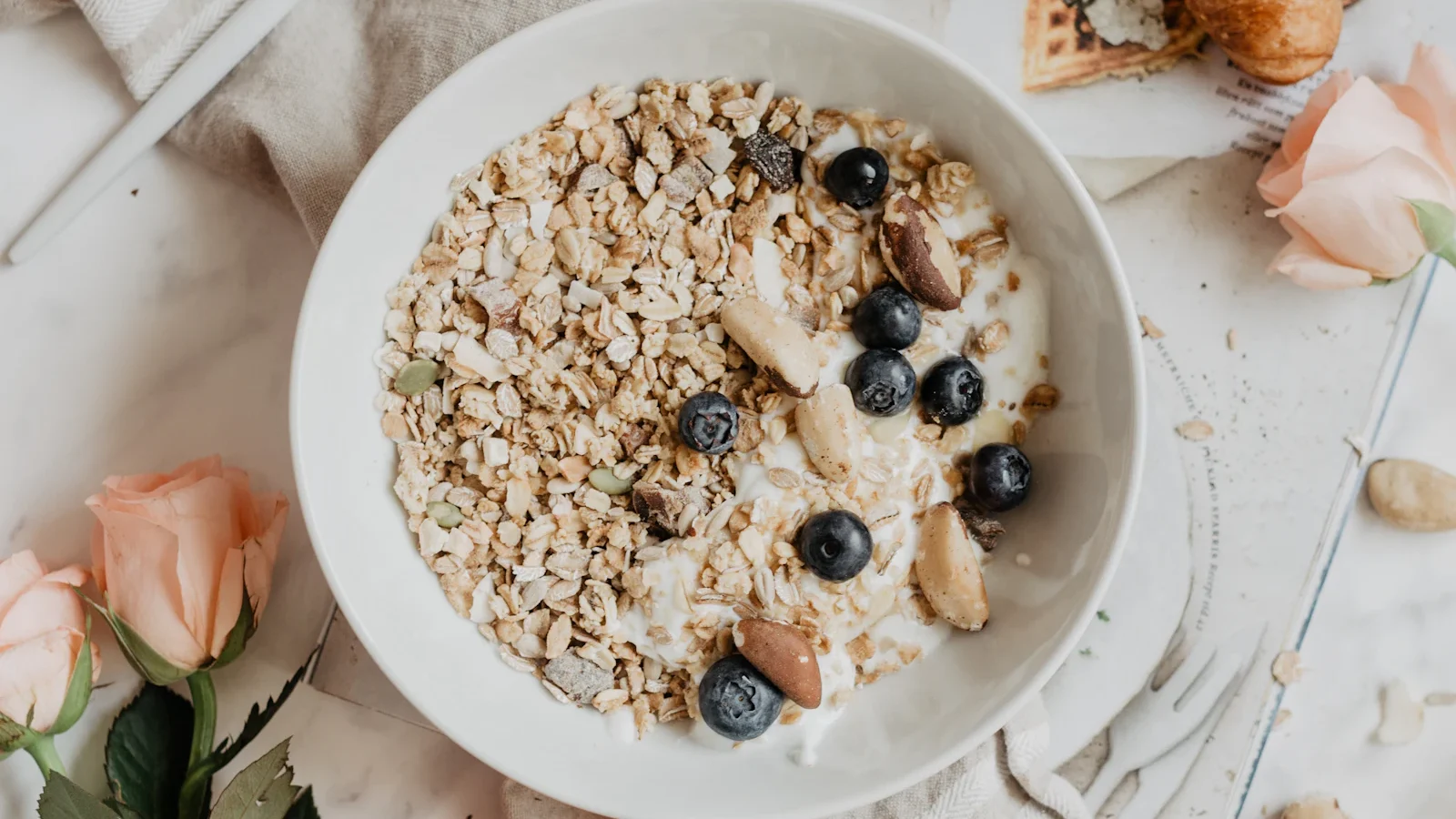Bowl of oatmeal with blueberries on a white table
