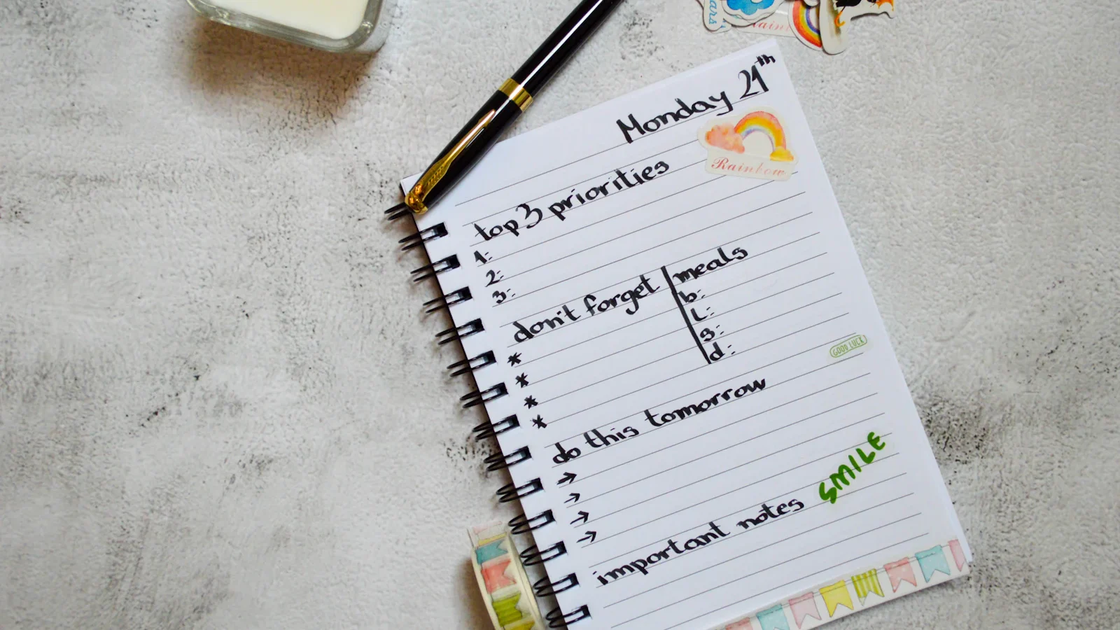 Checklist in a notebook with a pen on a white surface
